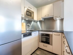 A modern kitchen with stainless steel appliances, a built-in oven, and a dishwasher.