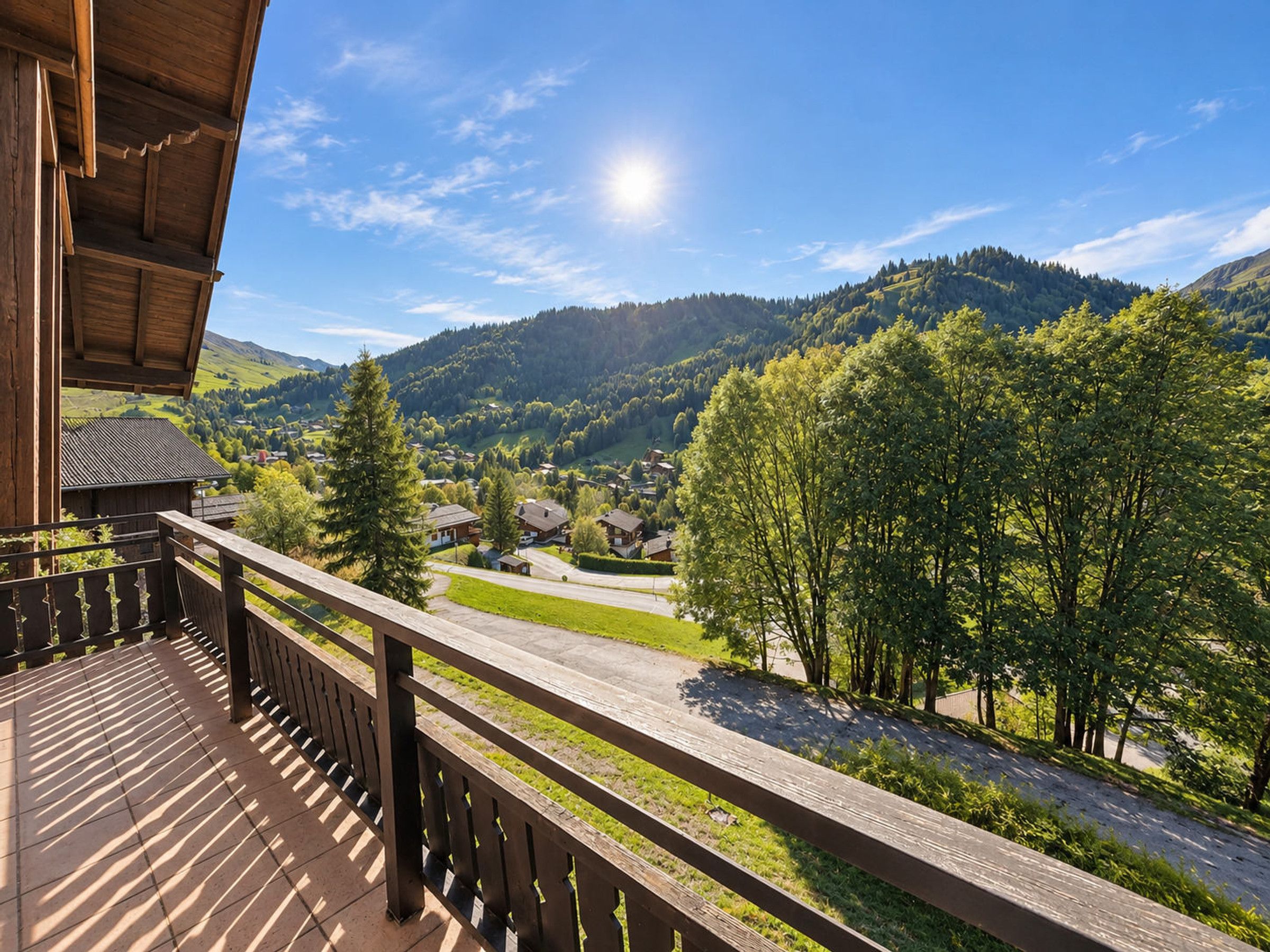 Ein Holzbalkon mit Blick auf ein Dorf und Berge.