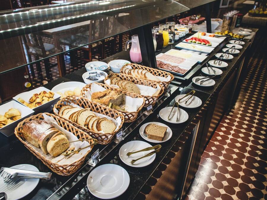 A buffet setup with various food items and utensils.