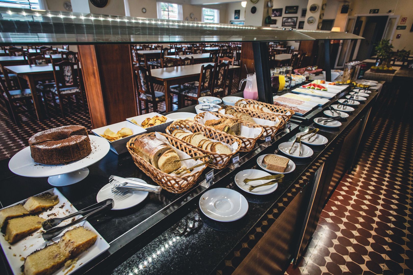 A buffet setup with various food items and utensils.