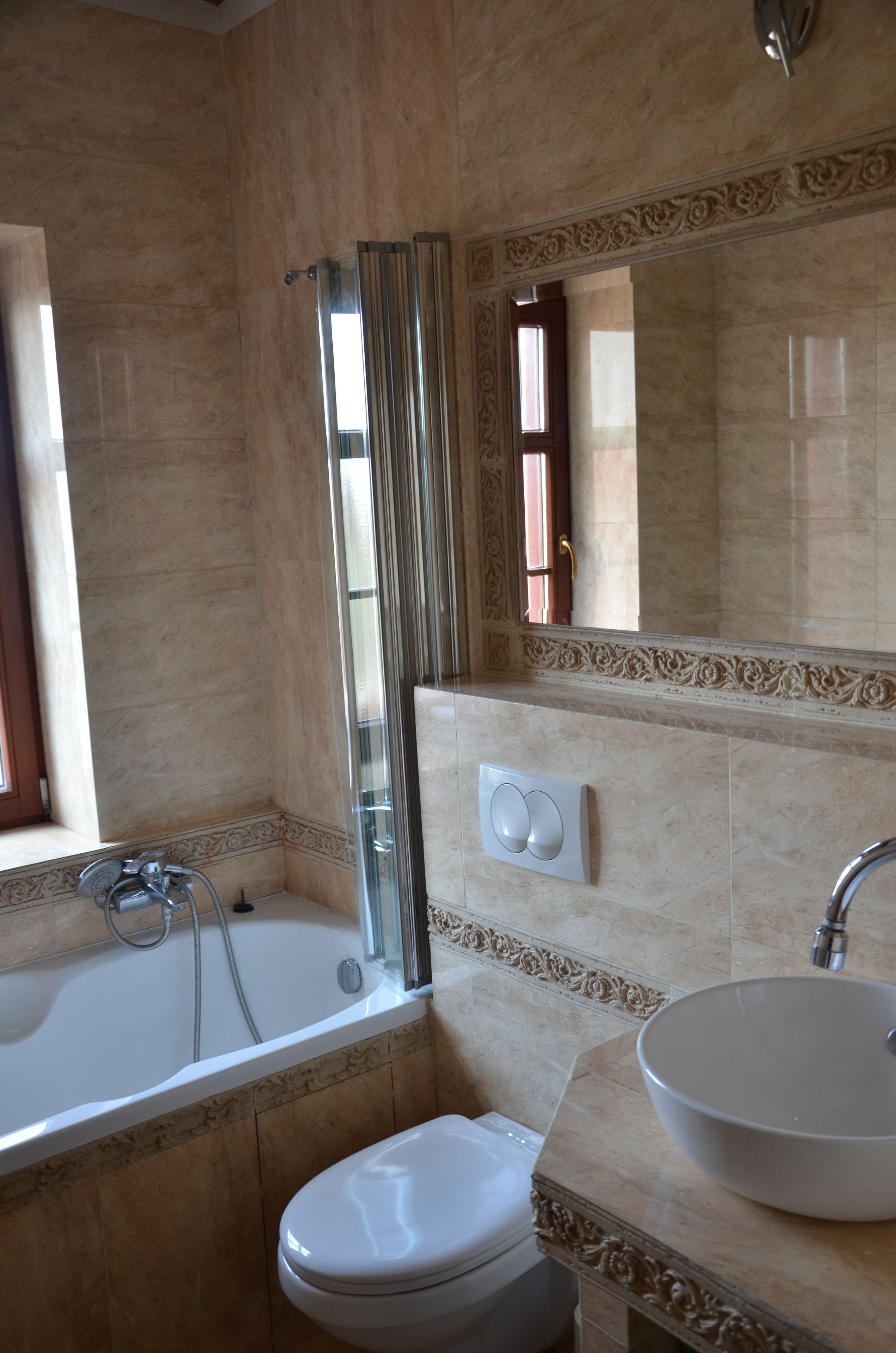 A bathroom with a bathtub, toilet, and sink.