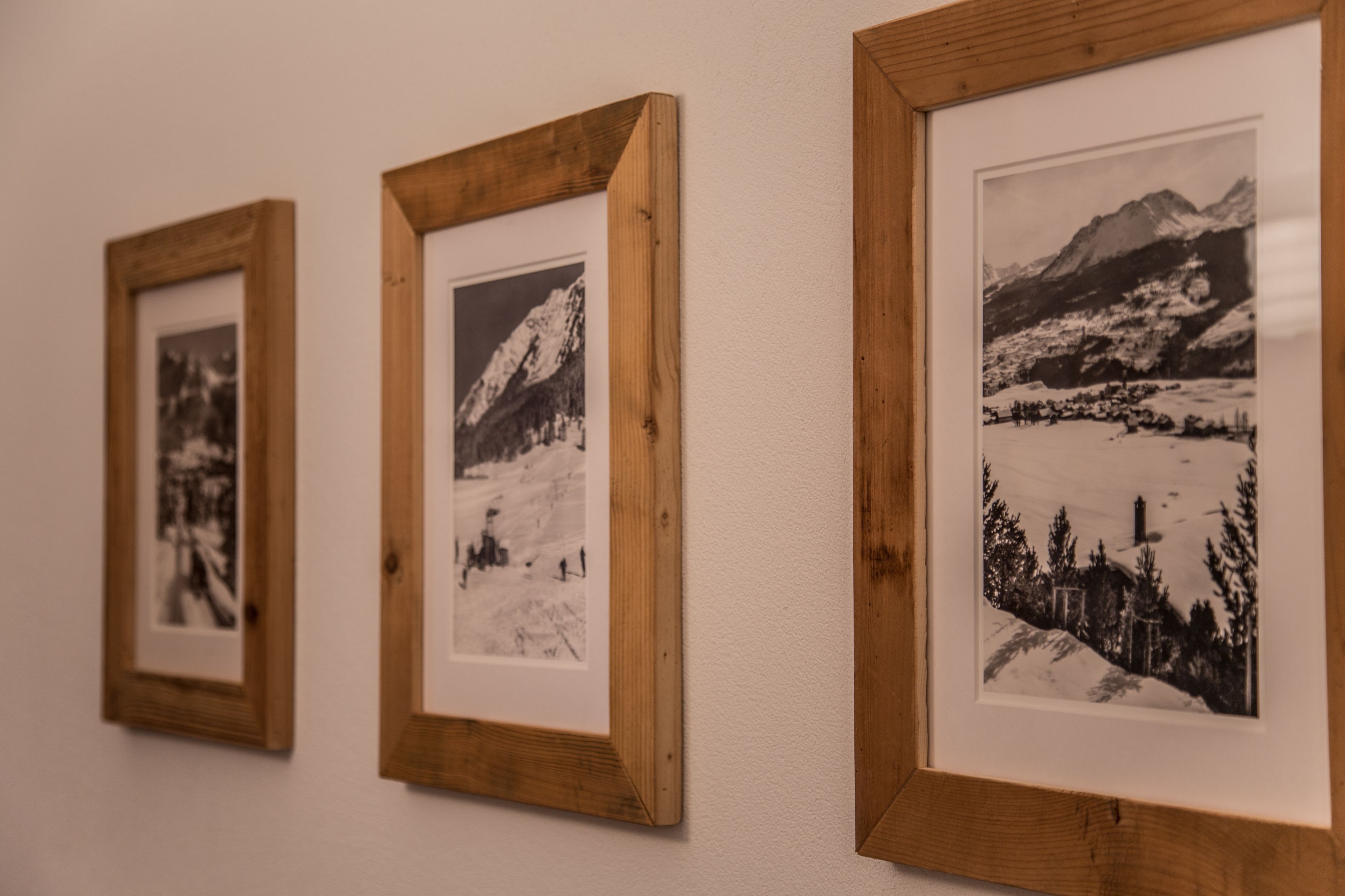 Drei gerahmte Fotografien an einer Wand.