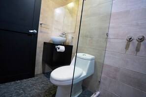 Features a bathtub, sink, and shower enclosure.