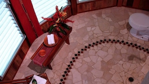 Un baño con piso de mosaico, una banca de madera, un inodoro y una bañera.