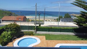 Zona residencial con piscina, vista al océano y cielo despejado.