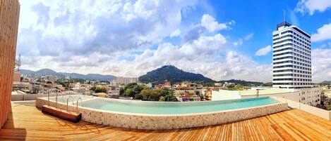 Una piscina al aire libre, tumbonas