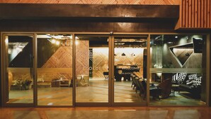 A modern building with a wooden interior and a glass entrance. - EcoLoft Hotel (Phuket)