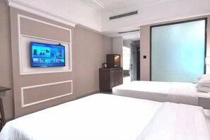 A hotel room with two beds, a television mounted on the wall, and a sliding door leading to another room.