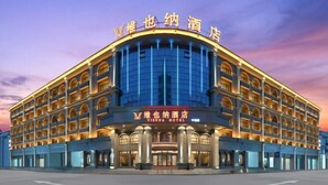 A large, multi-story hotel with a prominent curved facade and arched windows.