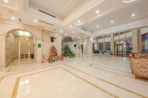 A spacious lobby with a polished marble floor, a grand staircase, and a chandelier. - Vienna Hotel (Ninghai) (Ninghai)