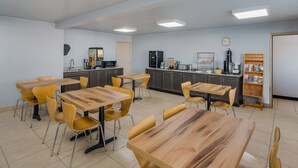 A modern kitchen with wooden countertops, a sink, and a coffee machine.