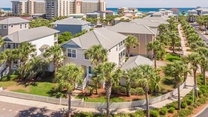 A coastal residential area with houses, palm trees, and a view of the ocean. - Eden's Estate - Pet Friendly, Heated Community Pool, Bikes Included! (Miramar Beach)