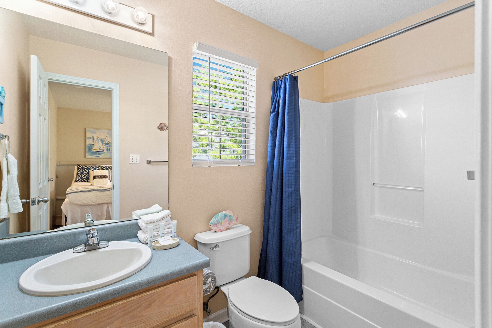A bathroom with a sink, toilet, and shower.