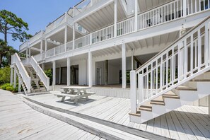 A multi-level wooden deck with a staircase, a picnic table, and a door marked '301'.