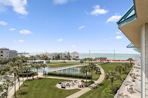A resort with a pool, palm trees, and a view of the ocean. - Amalfi Coast 412A - Gulf Views! Community Pool! Fitness Facility! Tennis Courts! (Miramar Beach)