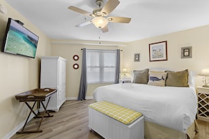 A bedroom with a bed, a ceiling fan, a television, a wardrobe, and a window with blinds. - Amalfi Coast 412A - Gulf Views! Community Pool! Fitness Facility! Tennis Courts! (Miramar Beach)