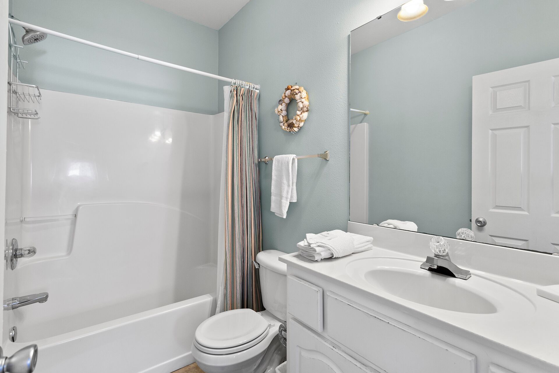 A bathroom with a bathtub, toilet, and sink.