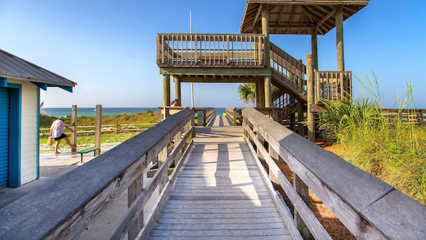 A wooden boardwalk leading to a beach area with a small building and a lookout tower. - Gone Coastal - Dune Allen Beach! 30A! Community Pool! Steps to the Sand! (Santa Rosa Beach)