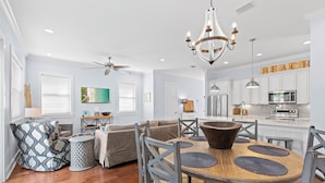 A modern kitchen with white cabinets, stainless steel appliances, and a wooden island with a large bowl. - Gone Coastal - Dune Allen Beach! 30A! Community Pool! Steps to the Sand! (Santa Rosa Beach)