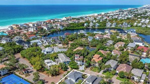 An aerial view of a coastal residential area with houses, a marina, and a beach. - Amazing Grace - Destiny West, Heated Private Pool, Fitness, Community Hot Tub! (Destin)