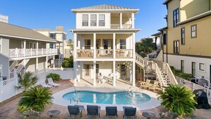 A two-story building with a pool and outdoor seating. - Whitesand - Gulf View, Heated Private Pool, Short Walk to the Beach! (Miramar Beach)