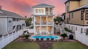 A two-story house with a pool, a covered patio, and a fenced backyard. - Whitesand - Gulf View, Heated Private Pool, Short Walk to the Beach! (Miramar Beach)