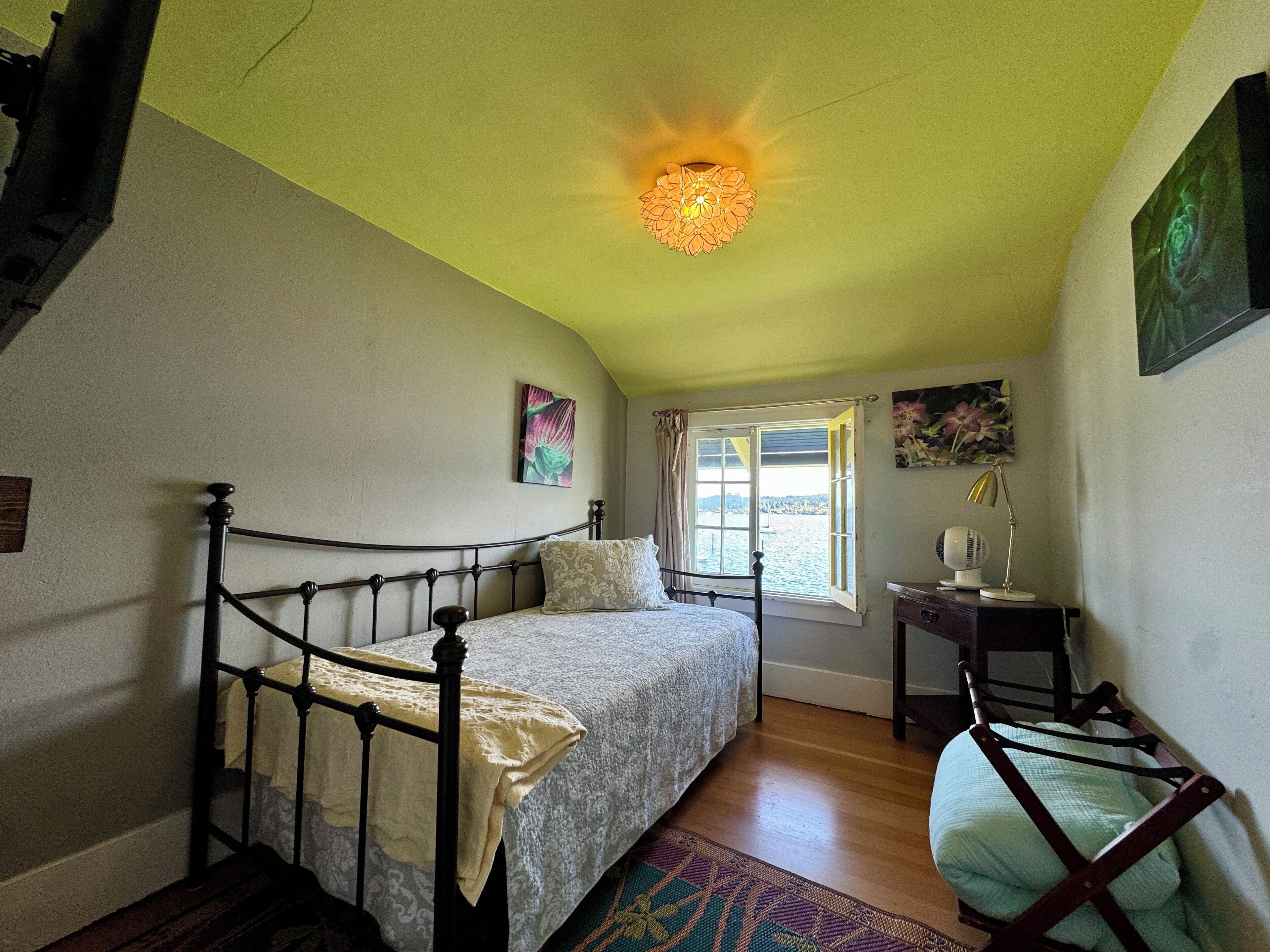 East side twin bedroom with tv.