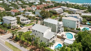 A residential area with houses, a swimming pool, and a view of the ocean. - Sandy By The Sea - Blue Mountain Beach! Gulf View! Private Pool! Pet Friendly! (Santa Rosa Beach)