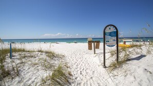 A beach with a signboard, white sand, and the ocean. - Breakaway (Updated) - Steps to the Beach! Private Pool! Great Outdoor Space! (Miramar Beach)