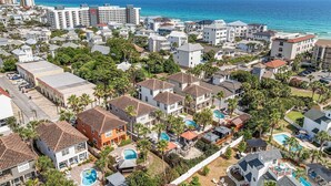 A coastal residential area with multiple-story buildings, a large swimming pool complex, and a view of the ocean. - Breakaway (Updated) - Steps to the Beach! Private Pool! Great Outdoor Space! (Miramar Beach)