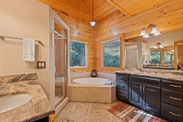 A modern bathroom with a freestanding bathtub, a large mirror, and a marble countertop. - Pilots Porch, Hot Tub, Sleeps 8, in Gated Smoky Mtn. Retreat Community (Maggie Valley)