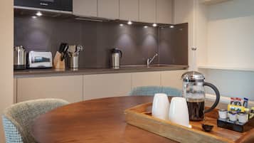 A modern kitchen with a Bosch microwave, a coffee maker, and a toaster on the counter.