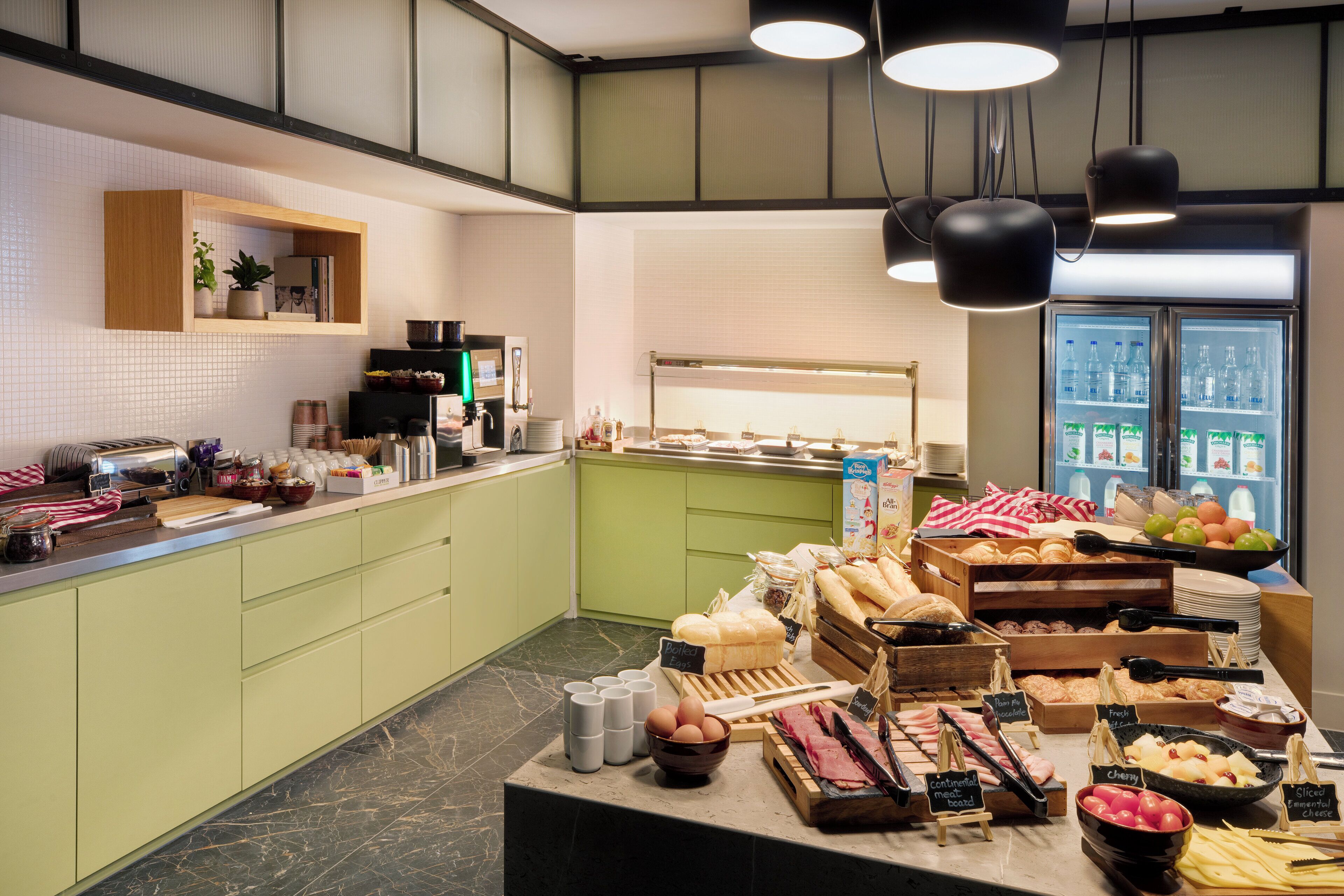 A breakfast buffet with various food items and a coffee station.