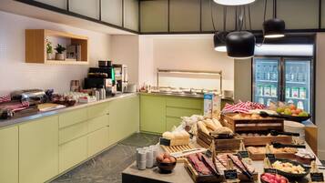 A breakfast buffet with various food items and a coffee station.