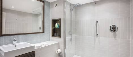 A modern bathroom with a sink, toilet, and shower.