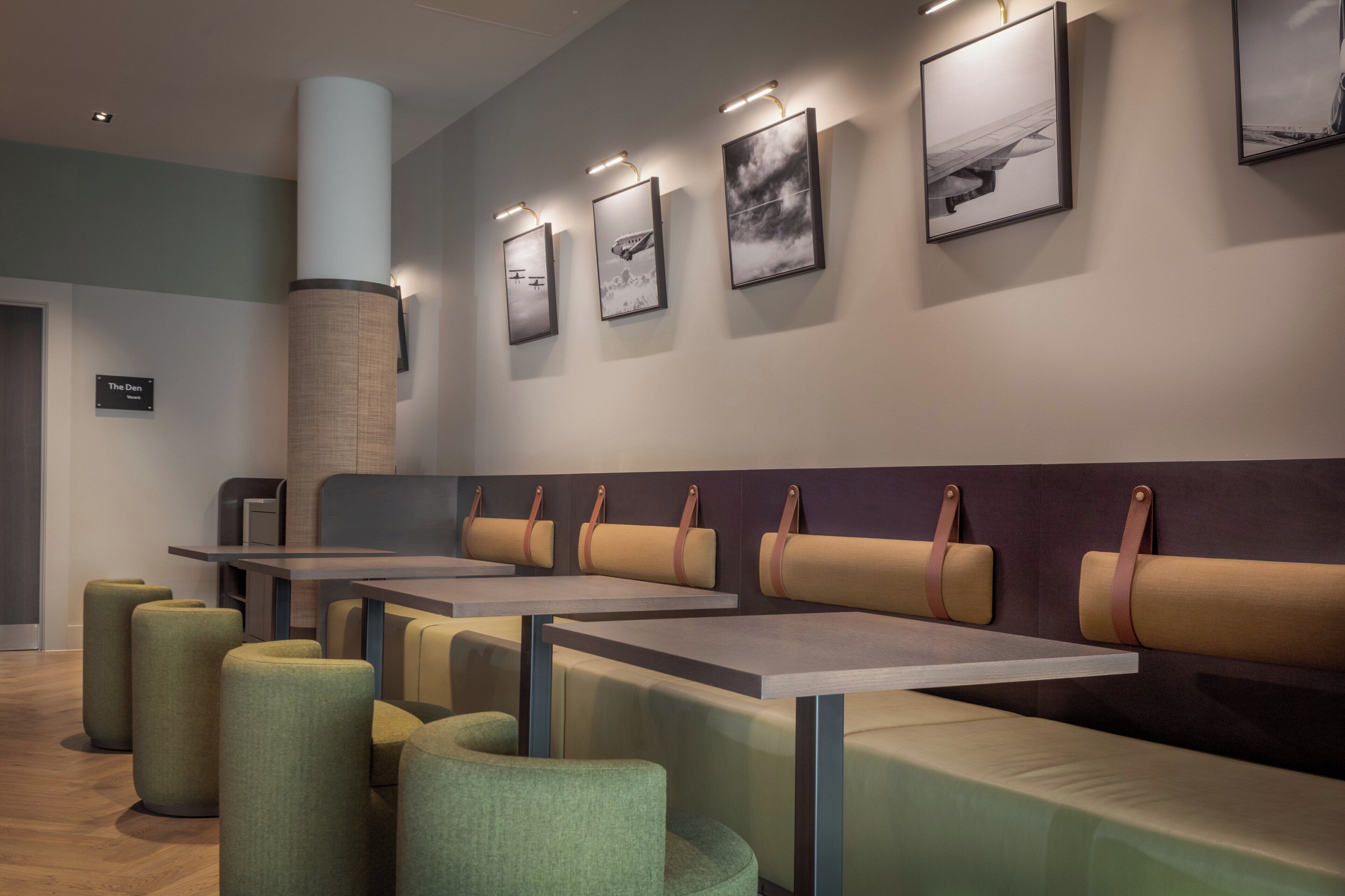 A modern interior with seating arrangements and artwork on the walls.