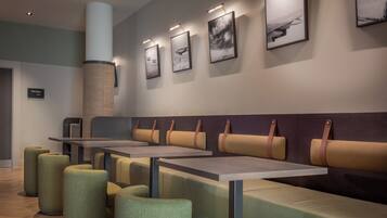 A modern interior with seating arrangements and artwork on the walls.