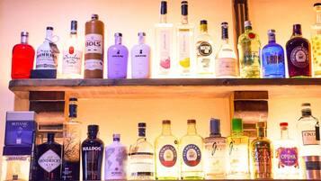 Una estantería de bar llena de diversas botellas de ginebra y otras licores.