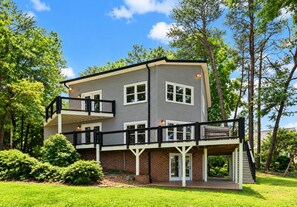 A two-story house with a balcony, a brick foundation, and a covered porch. - What A View! Perfect Family Meeting Place. BIG Views!  Optional Boat Rental. (Sherrills Ford)