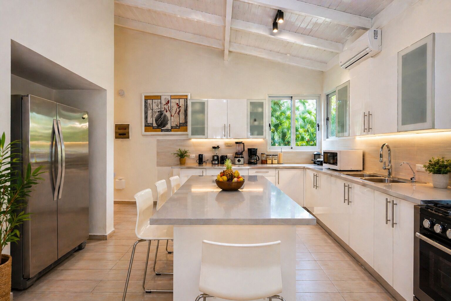 A modern kitchen with a central island, stainless steel appliances, and a view of greenery outside.