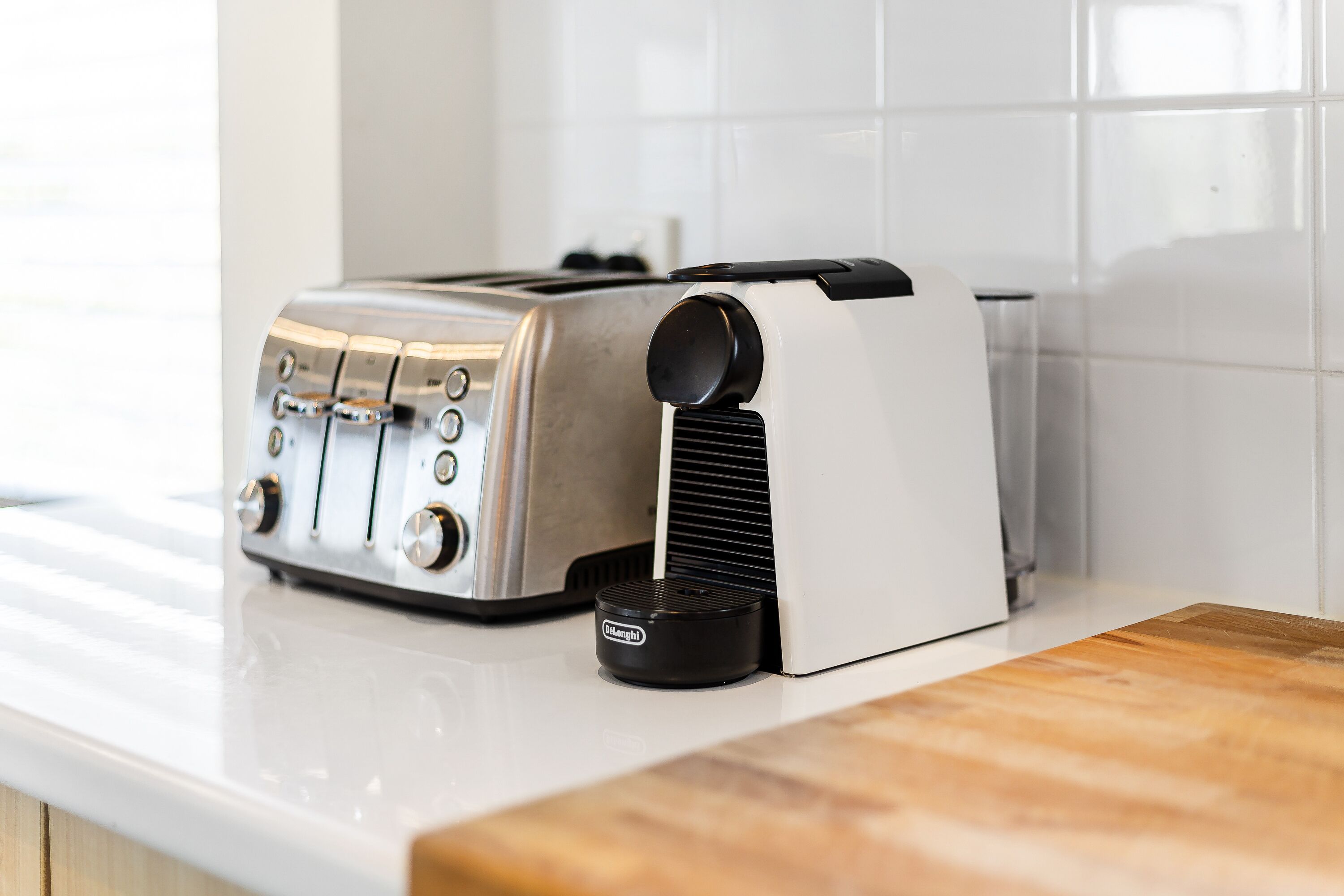 A kitchen with a toaster and a coffee maker on the counter.