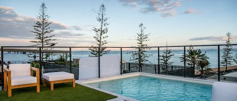 Outdoor pool, open 6:30 AM to 10:00 PM, pool loungers