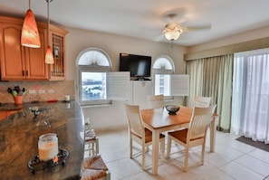 Enjoy meals in the kitchen with a dining area featuring a table and chairs.
