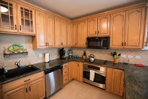 Enjoy cooking in this well-equipped kitchen with a dishwasher, oven, and microwave.
