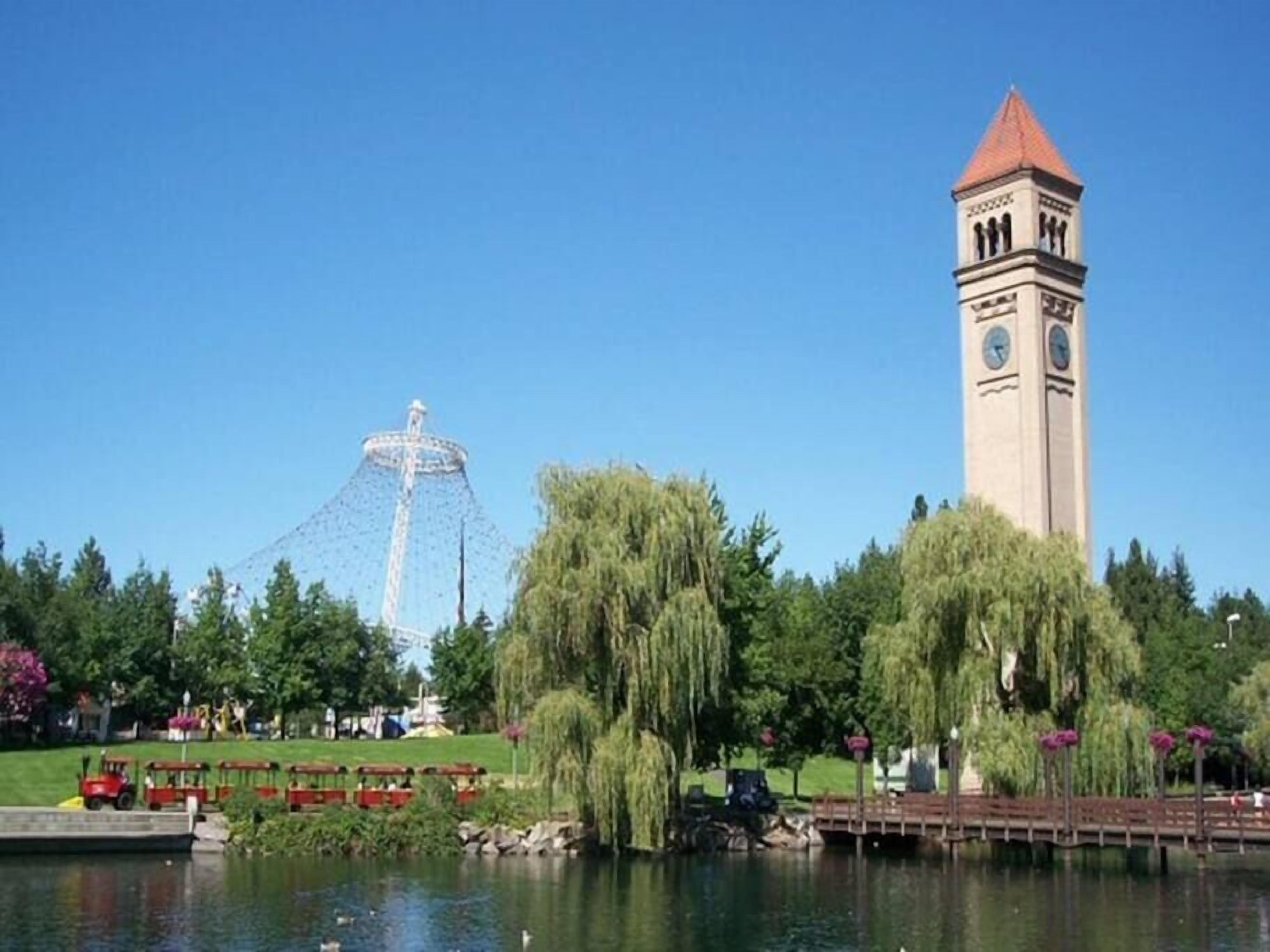 Un parc doté d’un plan d’eau, d’une tour horloge et d’une grande roue.