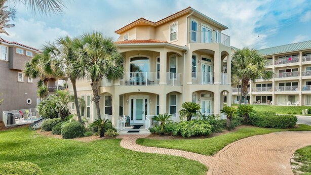 A multi-story hotel with a beige facade, balconies, and a well-maintained lawn. - Bird of Paradise, see the # of 5-stars-Just steps from Beach (Miramar Beach)