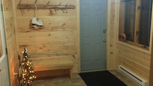 A wooden interior with a bench, a door, and a Christmas tree. - In The Heart Of The Hiawatha National Forest ~ Easy Access To The Trail System (Shingleton)