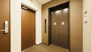 A hotel elevator with a control panel and a door with a keypad lock. - Rakuten STAY URBAN Nijo-jo (Kyoto)