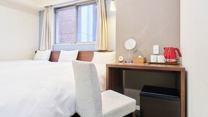 A hotel room with a bed, a desk with a mirror, a clock, and a red kettle. - Rakuten STAY URBAN Nijo-jo (Kyoto)