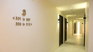 A hallway with directional signs indicating room numbers 301 to 307 and 308 to 313.